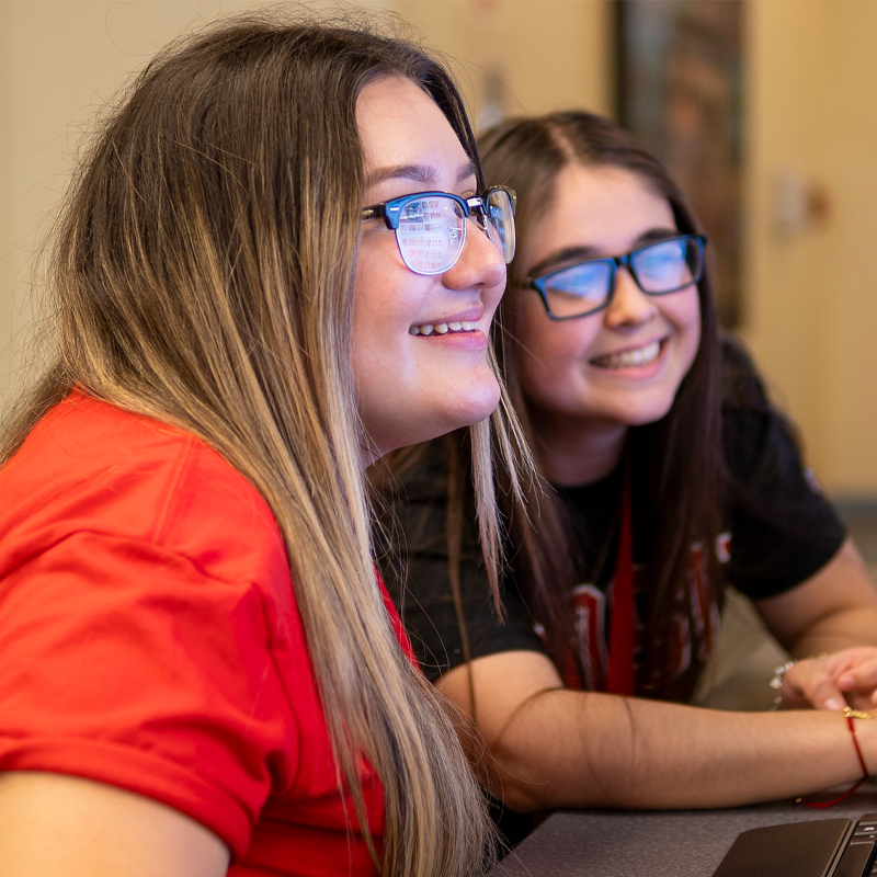 Two students looking at a computer