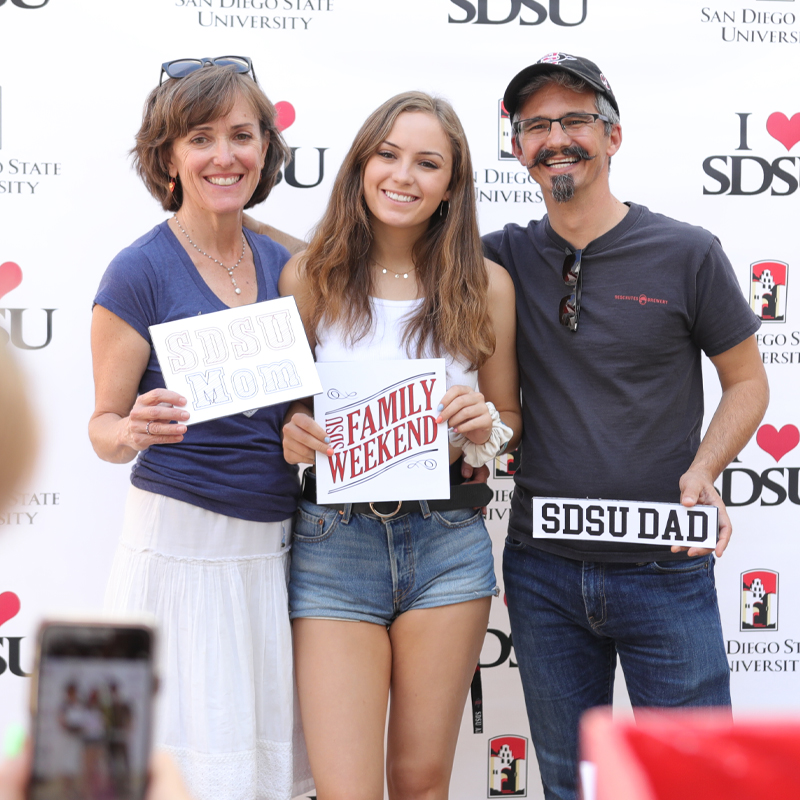 A student and their parents taking a photo